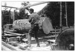 Don Archibald beside large log at Cade Sawmill in Hedley