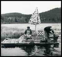 Couple and dog on motorized raft on Christina Lake, B.C.