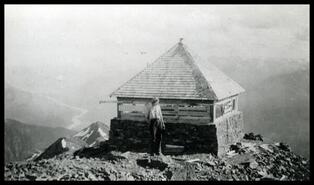 Unidentified woman at cabin at top of Mount Cartier