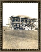 Group posing in front of Doukhobor dom (house) under construction in Saskatchewan