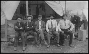 Chief R.N. Clerke with men outside a tent in Fernie