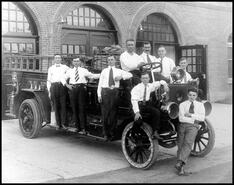 Men on truck outside the Vernon Fire Hall at 3005-30 St.
