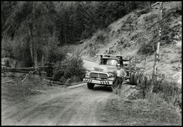 Larry Churchill posing with logging truck