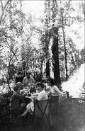 Group of children eating while attending Miss Topham Brown's drawing camp