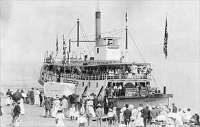Postcard of the crowd greeting the S.S. Aberdeen sternwheeler at the Peachland wharf