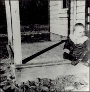Baby Mitchell Bain sitting on porch in Collettville