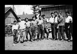 Group of boys outside a shack at unidentified internment camp