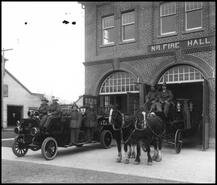 Firemen on fire truck and horse-drawn fire wagon at No. 1 Fire Hall