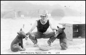Young soldier with two bear cub mascots of the 131st battalion at Camp Vernon