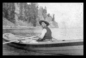 Jack O'Mahoney rowing a boat on Okanagan Lake