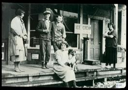Customers and staff with a dog in front of Peachland store
