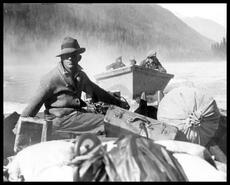 Men and supplies crossing the Columbia River by boat during construction of Big Bend Highway
