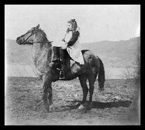 Lissa Hawes on horseback, Okanagan Landing?