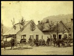 Men and horses and wagons on Main business street lower town
