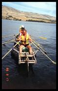 Members of the Okanagan Landing Volunteer Fire Department rowing their raft