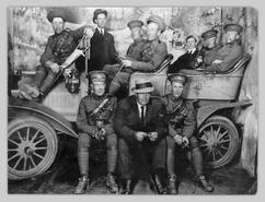 Group of soldiers pose with Model T