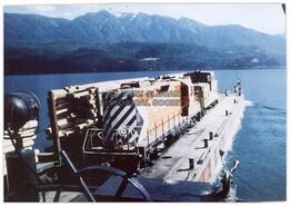 Barge with train and logs on Slocan Lake