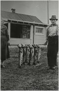 Peter Martin and an unidentified woman with his catch