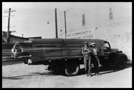 A.D. Booth and Fred Demmon with a loaded Booth truck on west side of S-A-F-E Ltd.