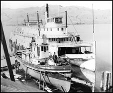 Canadian National No. 5 tugboat in drydock with the S.S. Okanagan sternwheeler docked to her right