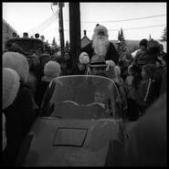 Santa (Art Davis) leaving "Shop Easy" store by snowmobile
