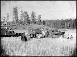 Threshing crew with the first 'header' machine in B.C. at the Wallace Ranch in Lansdowne