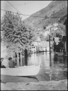 Two unidentified men in a row boat on Groutage Avenue during the devastating Columbia River 1948 flood