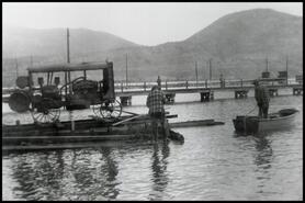 [Joe Trombley moving a compressor by barge to mine site]