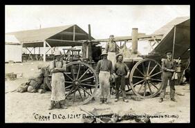"Cooks" D Company, 121st Battalion at wash field kitchen wagon, Camp Vernon