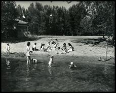 Young families at the beach at Christina Lake