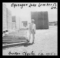 Charles Bagnall standing in the lumber yard of the Okanagan Lake Lumber Co. Ltd. at Okanagan Landing