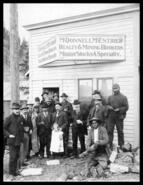 Group of men outside mining stock office