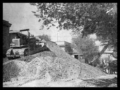 Bulldozer makes a mountain of gravel while resurfacing Barnard Avenue (30th Avenue)