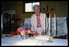 Lois Haggen on her 90th birthday cutting her cake