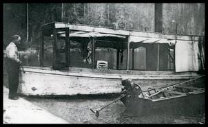 Ole Johnson with steam boat and row boat on Christina Lake, B.C.