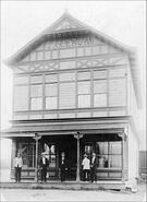 Five men on the front porch of the Cameron general store, Vernon