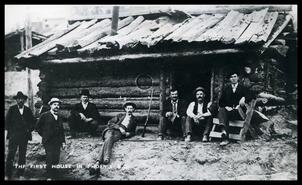 Postcard of men outside the first house in Phoenix, B.C.