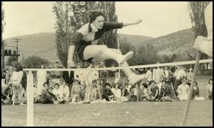 [Girl participating in high jump competition]