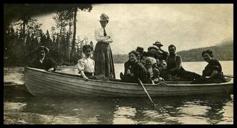 Group in row boat on Christina Lake
