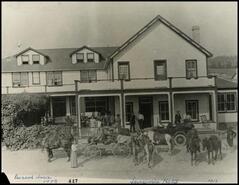 Mrs. Starke and daughter in group in front of Starke Hotel, Invermere