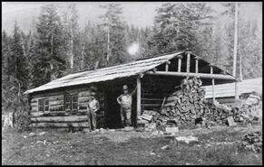 Jack Reid and Bill Thompson at log cabin