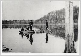 People in a flat bottomed boat on Old Darke Lake (later Fish Lake)