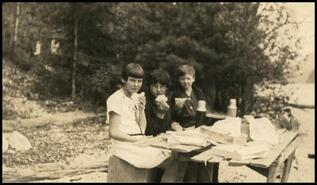 Audrey Blackbourne with others eating lunch outdoors