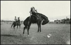[Bronco riding event at rodeo]