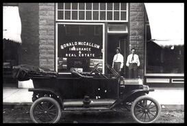 Automobile and two men in front of McCallum Insurance