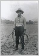 Unidentified man stands with lasso in hand 