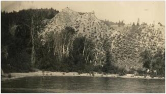 View of lakeshore with hill in the background at Chute Creek
