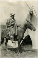 Man on horseback near teepee during opening of the David Thompson Memorial Fort