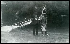 W.J. Sainsbury, Joan Deptford, and Judy Deptford in front of diving tower at Williamson Lake