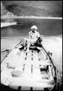 Mrs. Kingbaker and dog in boat on Mara Lake